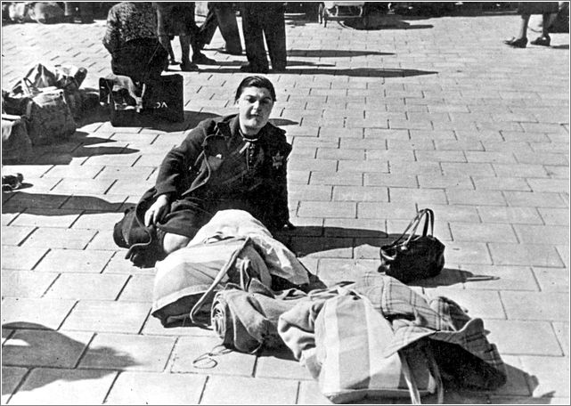 A Jewish woman sits at the assembly point for transport to Westerbork